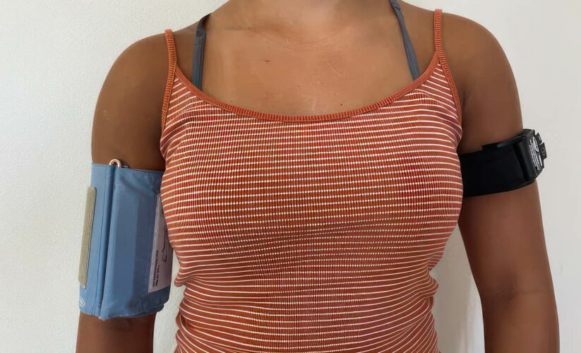woman using Kaatsu and blood pressure cuff
